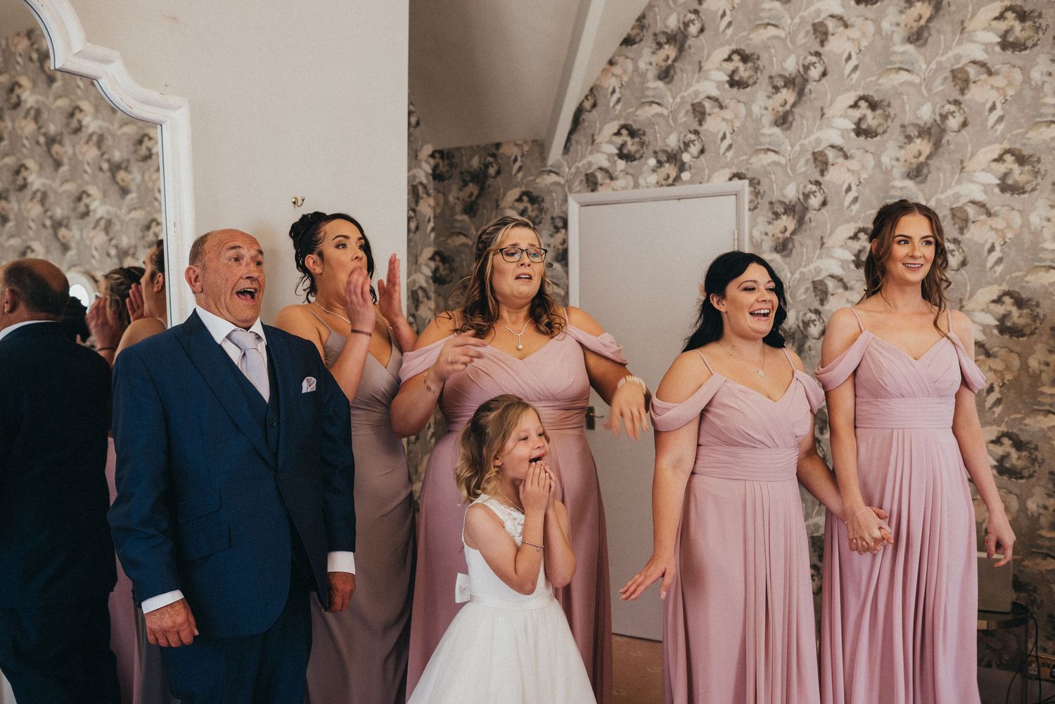 Wedding party in pink dresses posing together before the ceremony.
