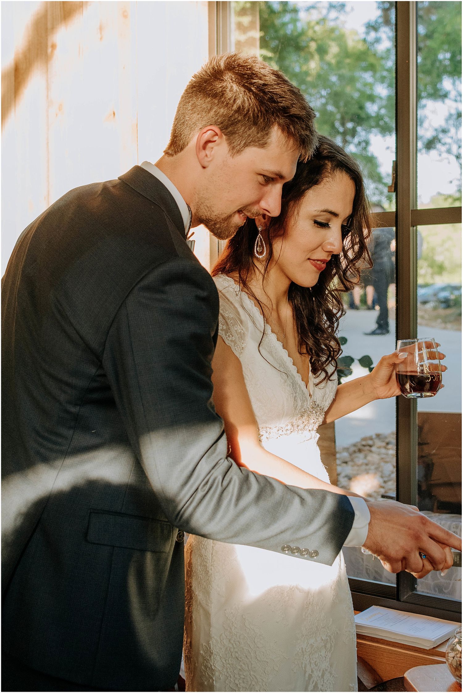 Intimate moment shared during an indoor wedding celebration with rustic wooden decor.