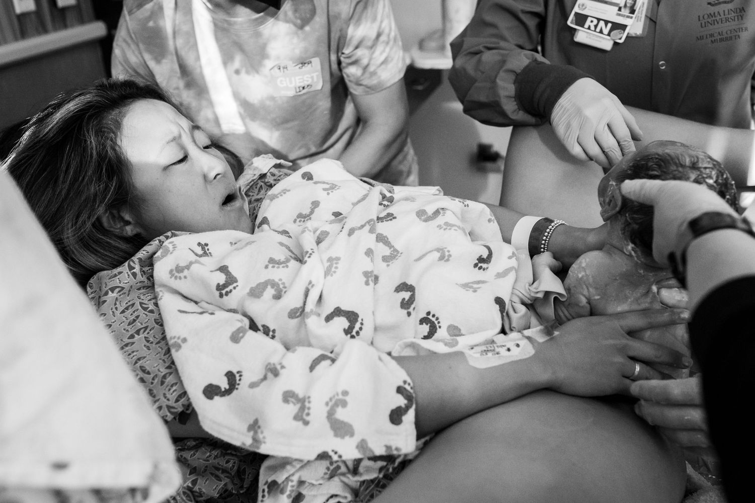 Woman catching her son during his birth in California