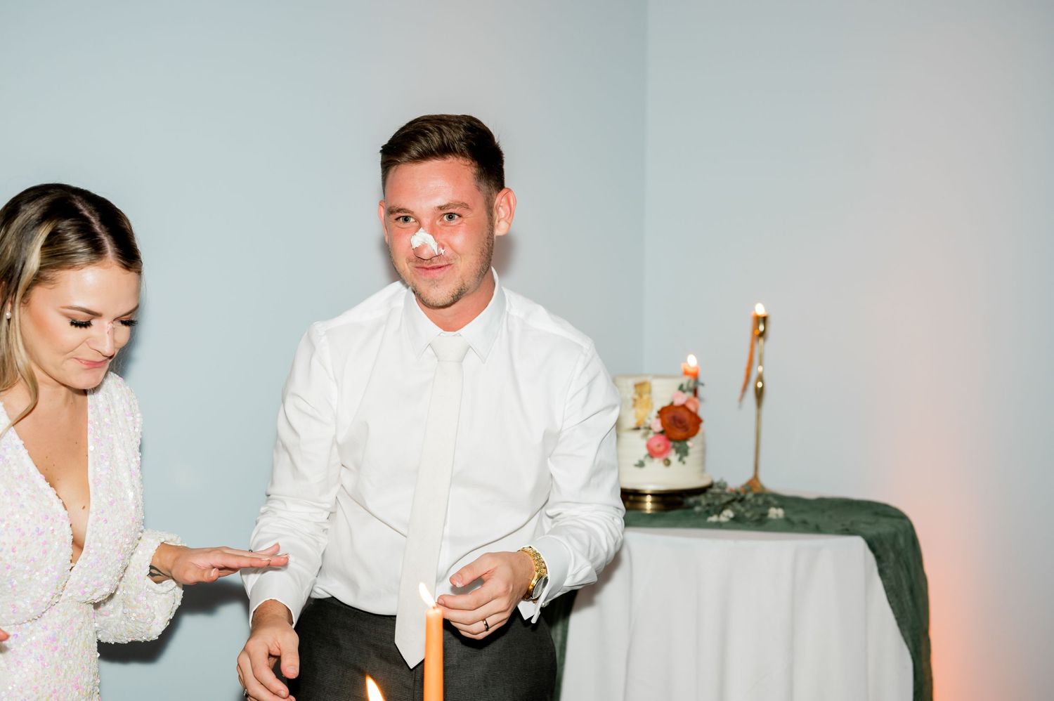 Candid moments of newlyweds enjoying their cake cutting ceremony at reception.