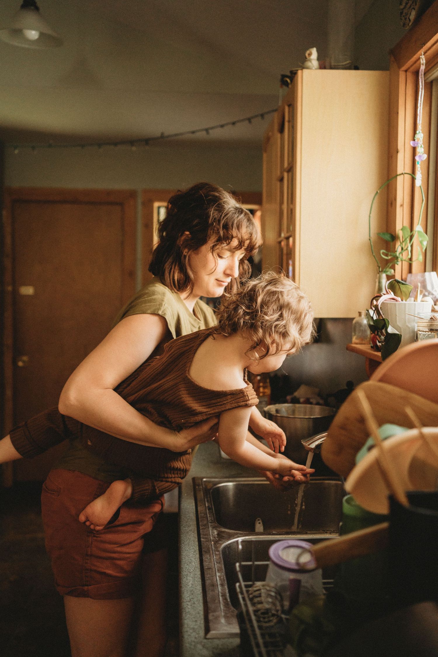 A heartwarming scene of cooking together at the kitchen sink.