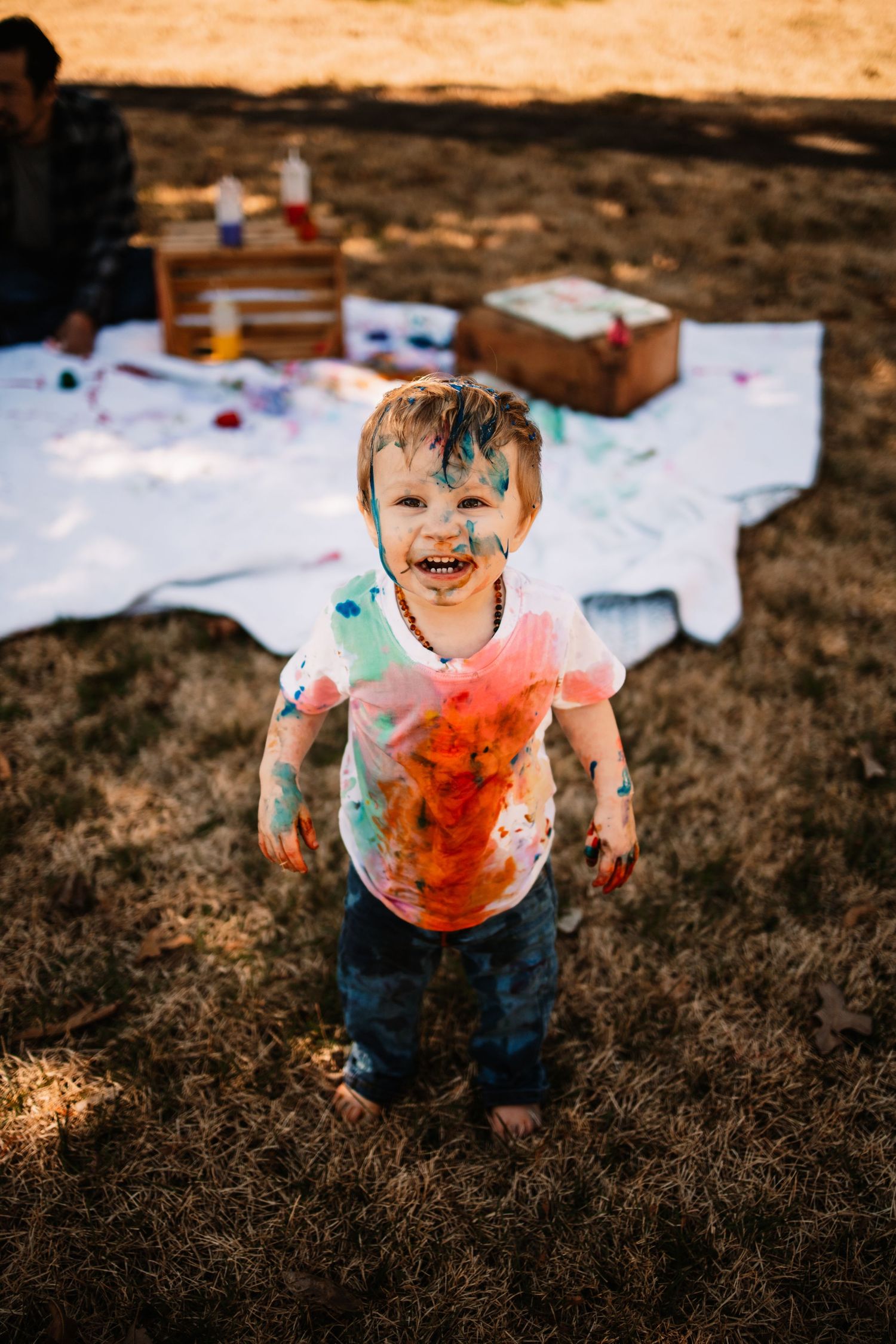 A toddler getting messy with a fun, unique paint party photo session in Oak Ridge, TN.