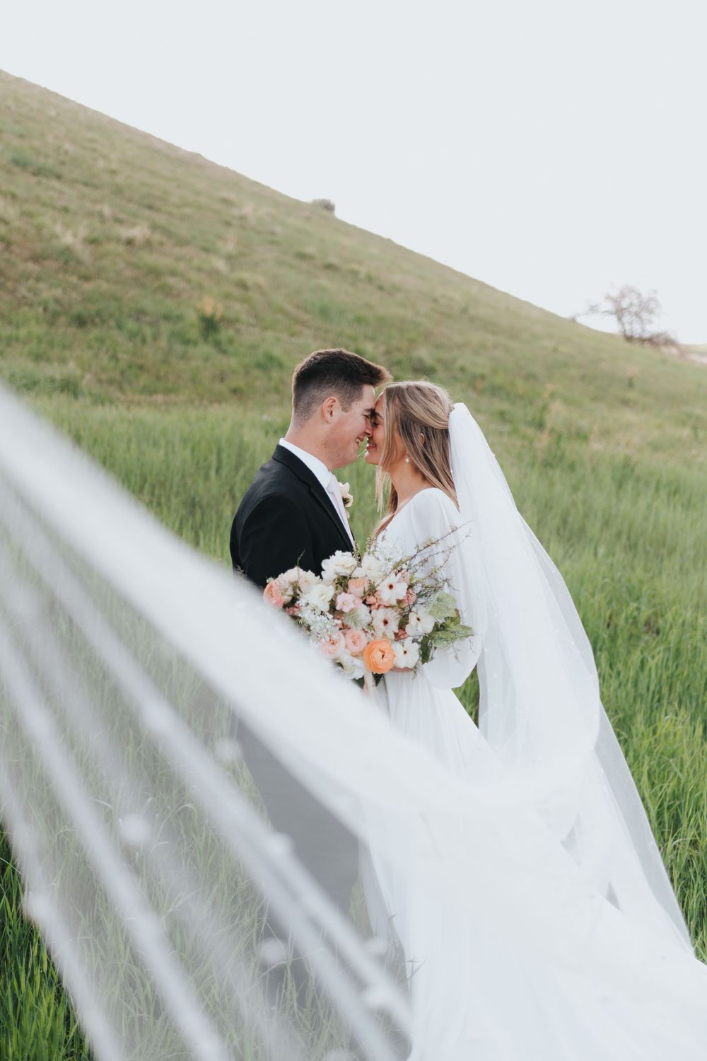 Bride and groom take spring bridal photos at Tunnel Springs Park, captured by their talented Utah wedding photographer.