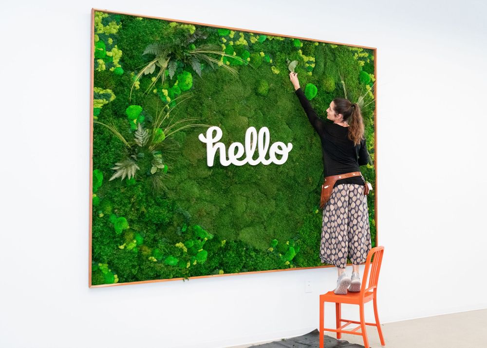 living plan wall sign maker putting finishing touches on her design for honey corporate client los angeles ca