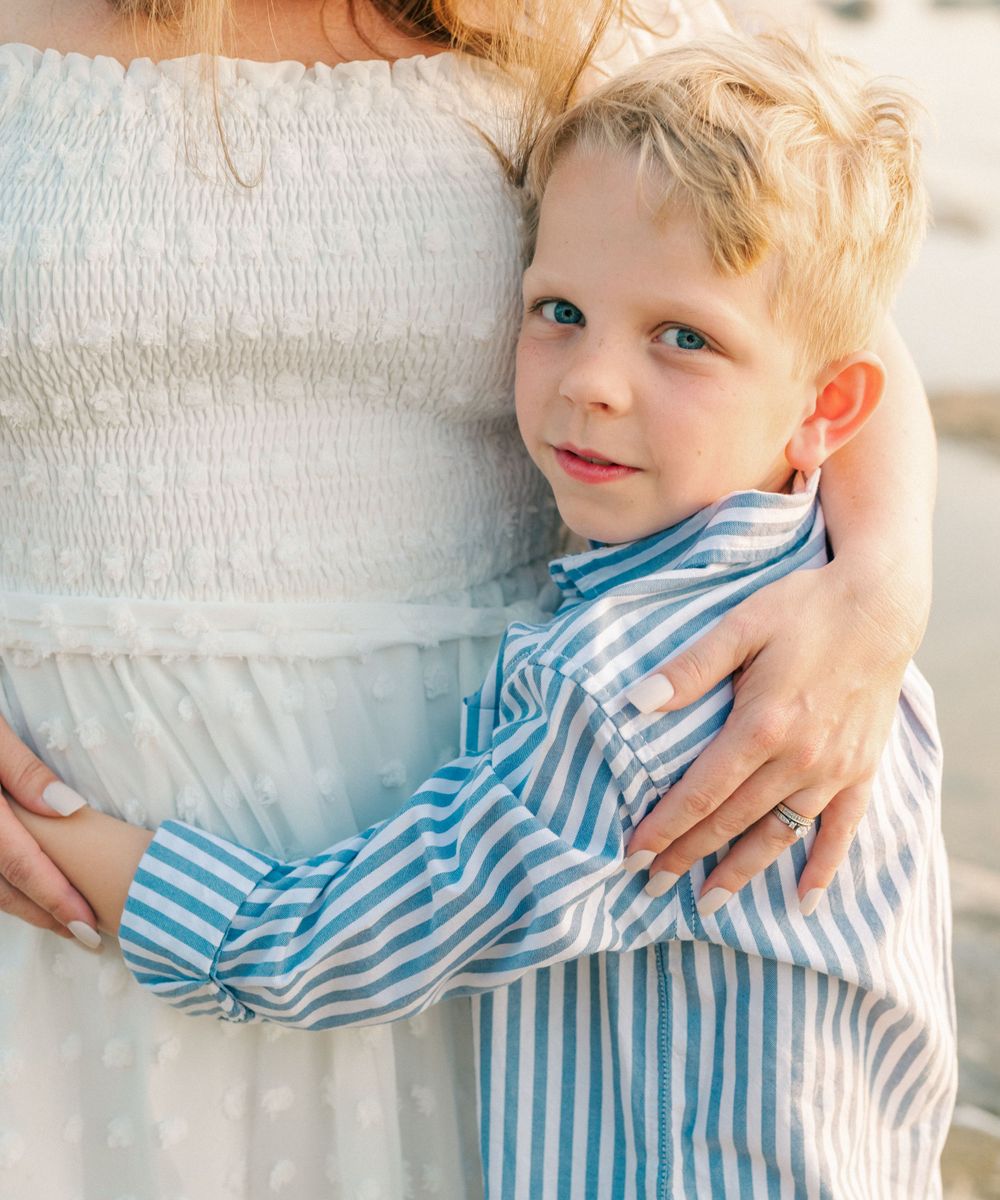 A tender moment captured showing embrace in soft natural light.