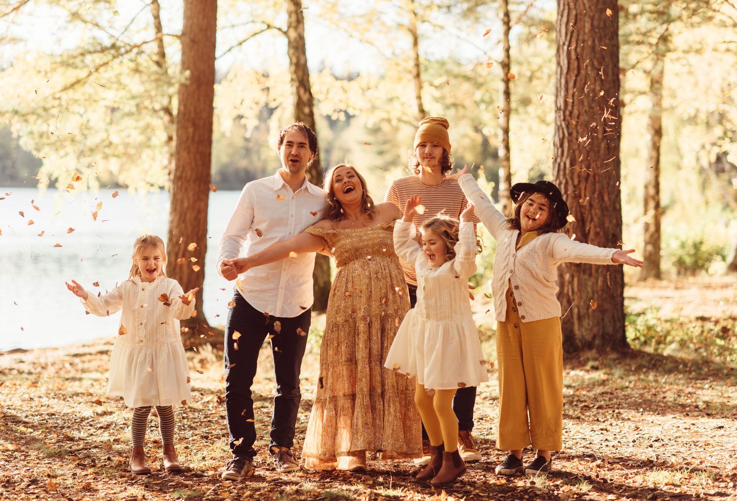 A series of outdoor family portraits in a sun-dappled forest setting during golden hour.