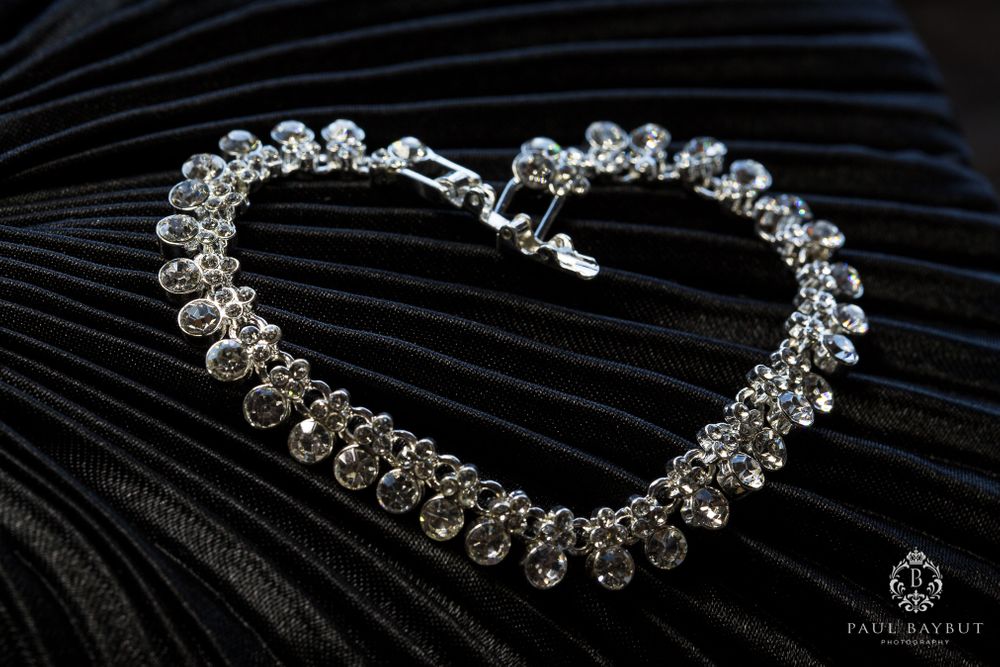 Sparkling crystal bracelet displayed on black textured fabric.
