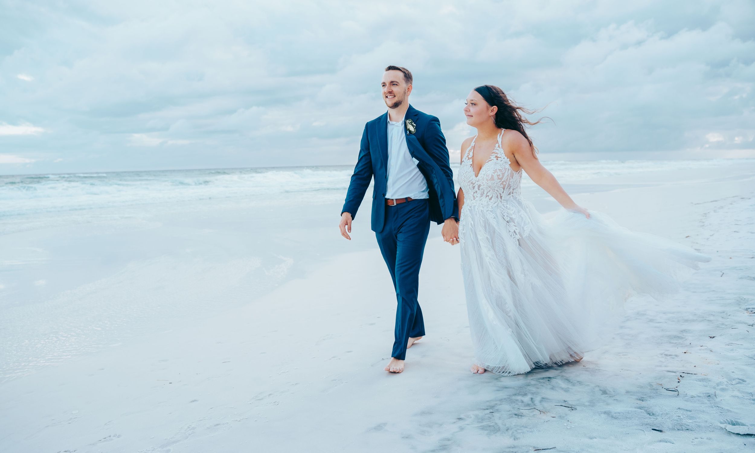 Young couple basks in the afterglow of their beach ceremony in Miramar Beach, Florida