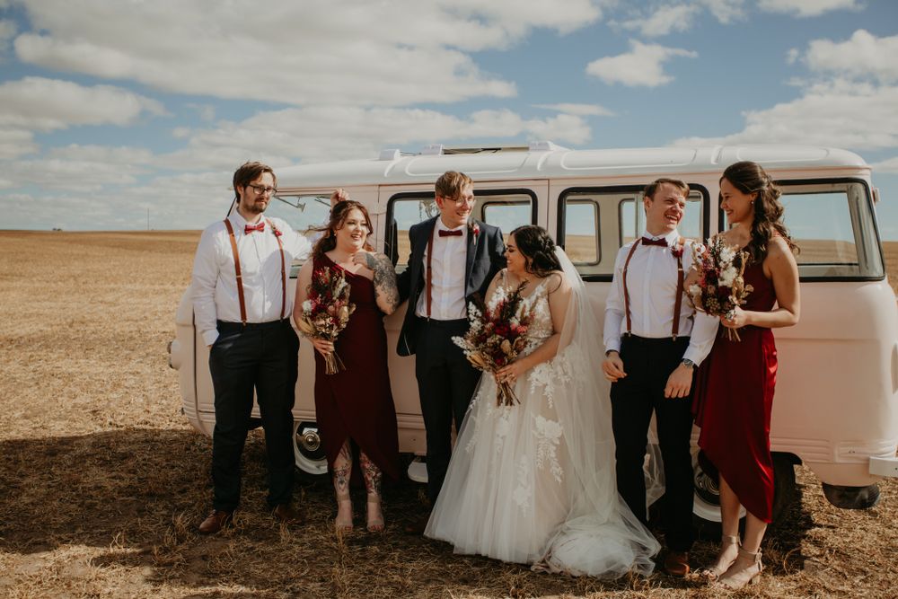 bridal party in white and red bridesmaid dresses in front of a Kombi van at Redwing Farm