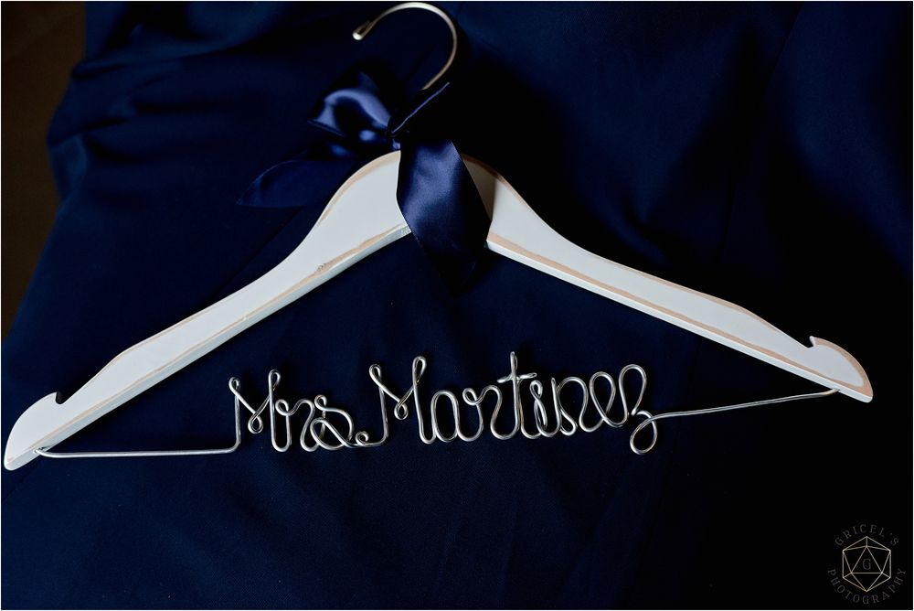 Custom white wedding dress hanger with wire text reading 'Mrs. Martinez'.