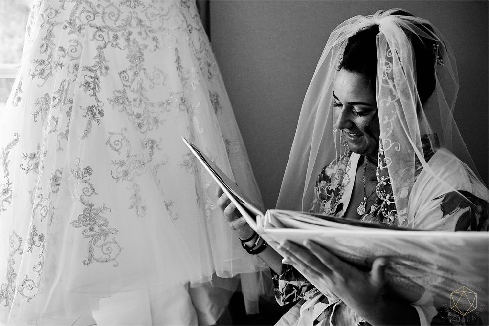 Black and white image showing wedding dress details and preparation moments.