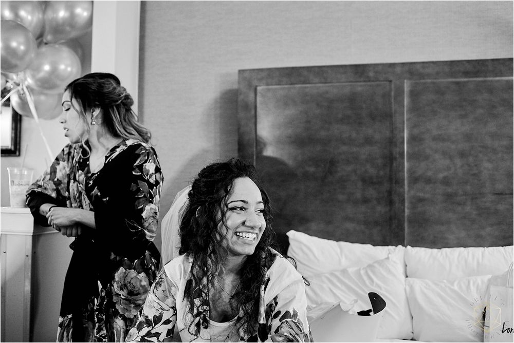 Black and white candid photo capturing joyful pre-wedding moments.
