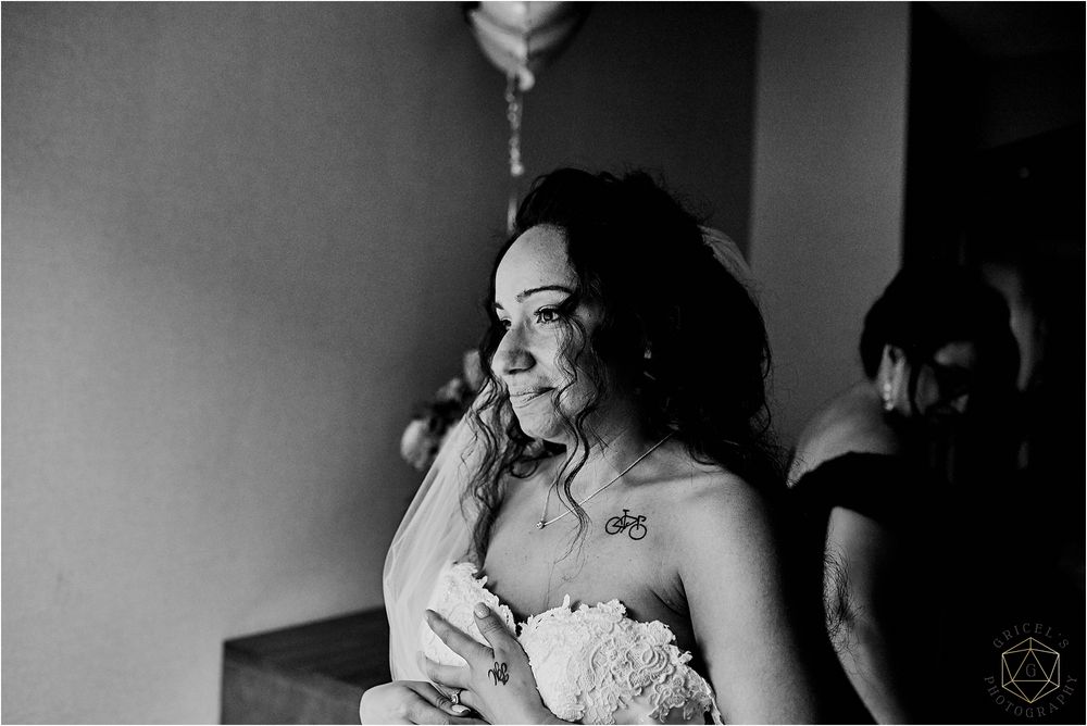 Black and white portrait showing emotional wedding preparation moment.