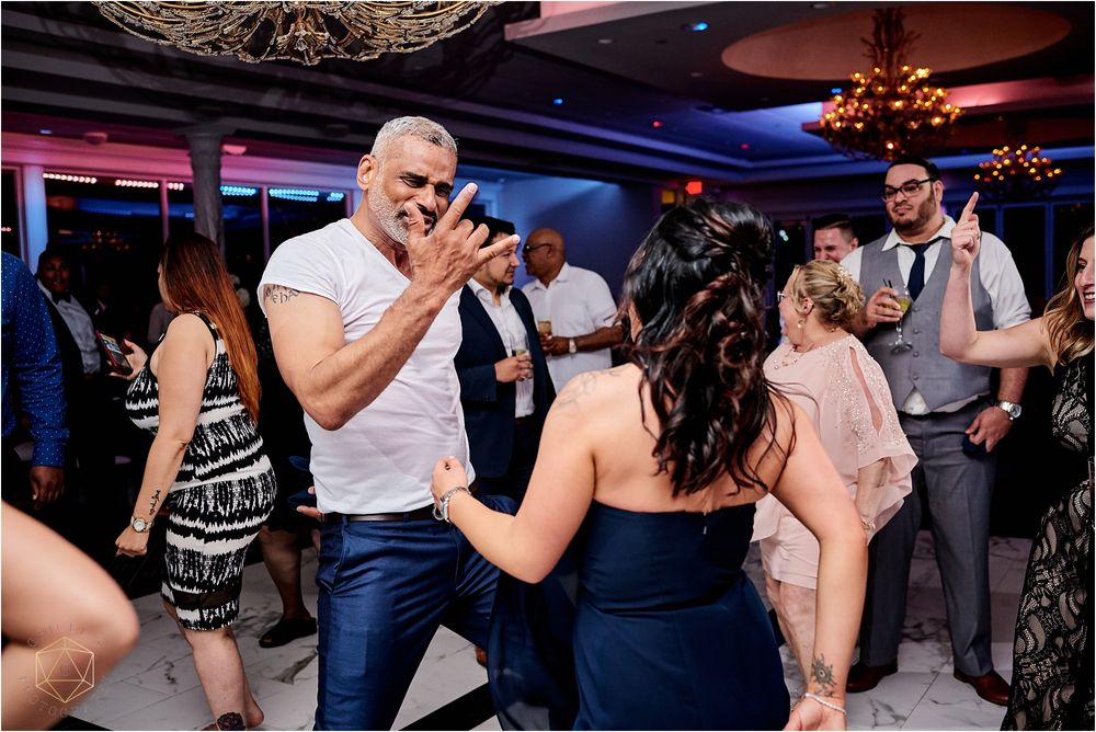 Wedding reception dance floor filled with guests enjoying lively celebration.