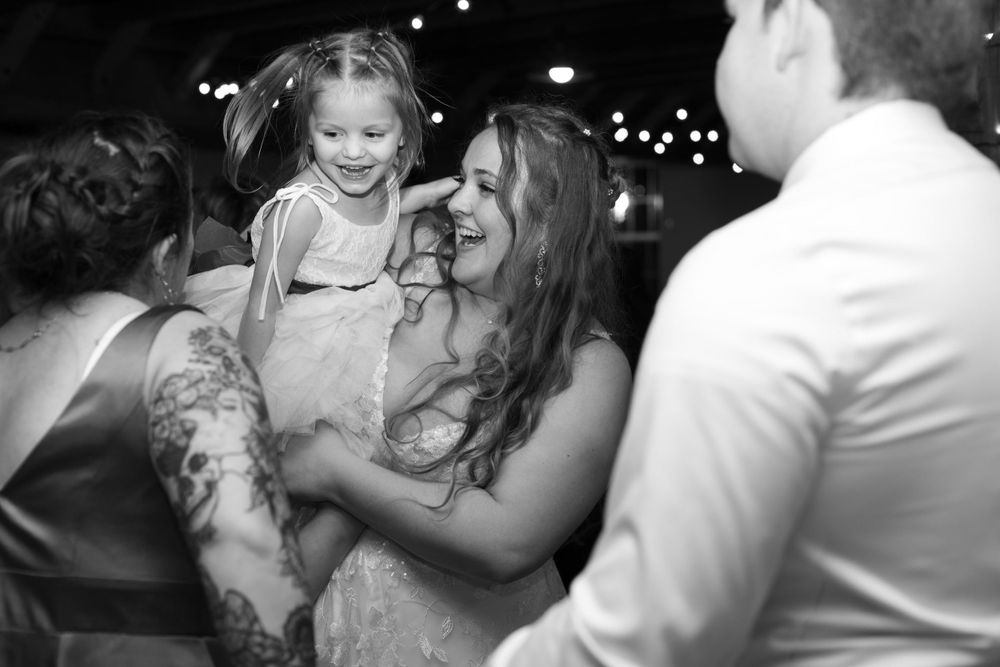 A joyful moment during a wedding reception with laughter and dancing.