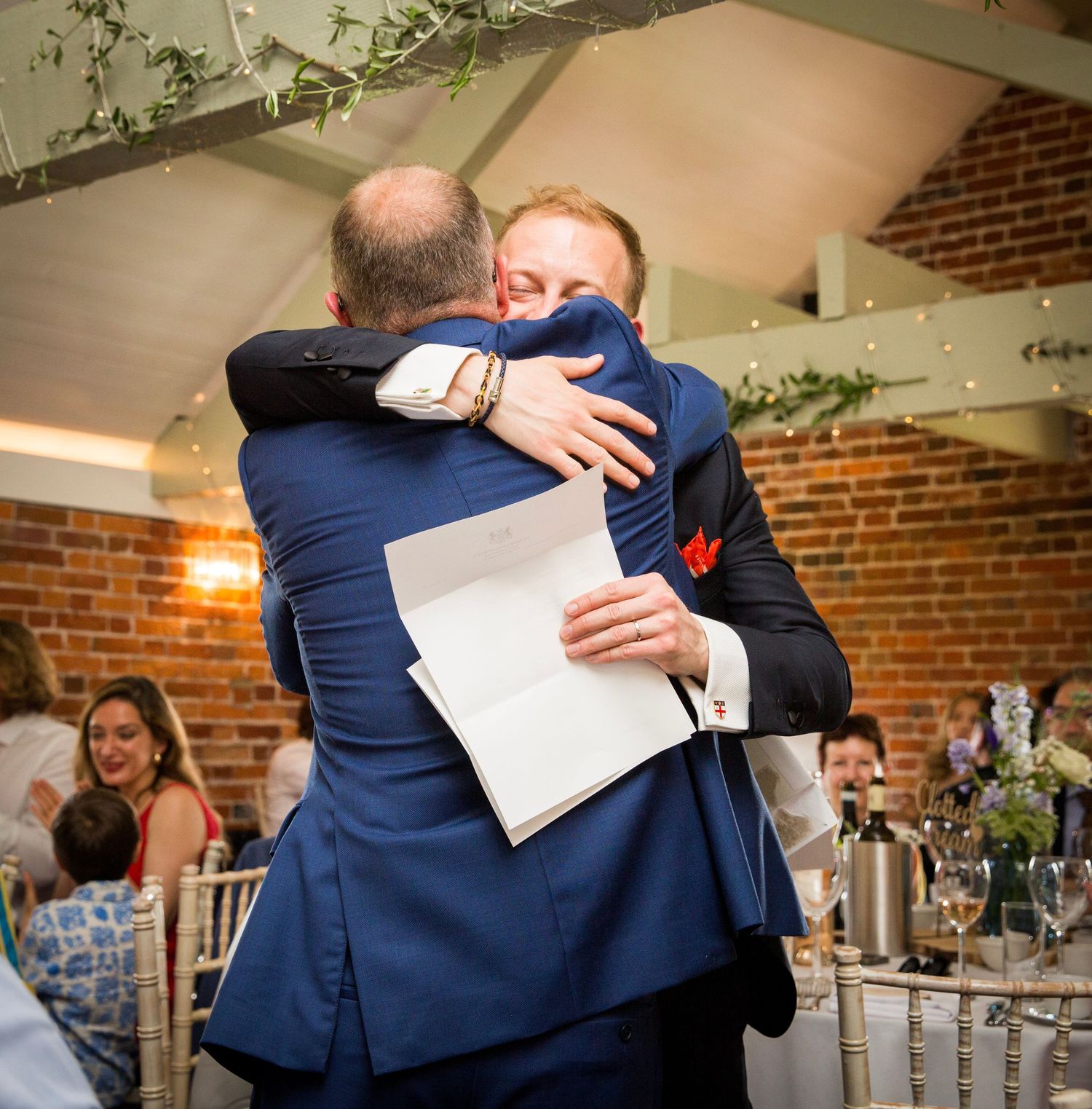 Heartfelt embraces shared during emotional wedding reception moments.