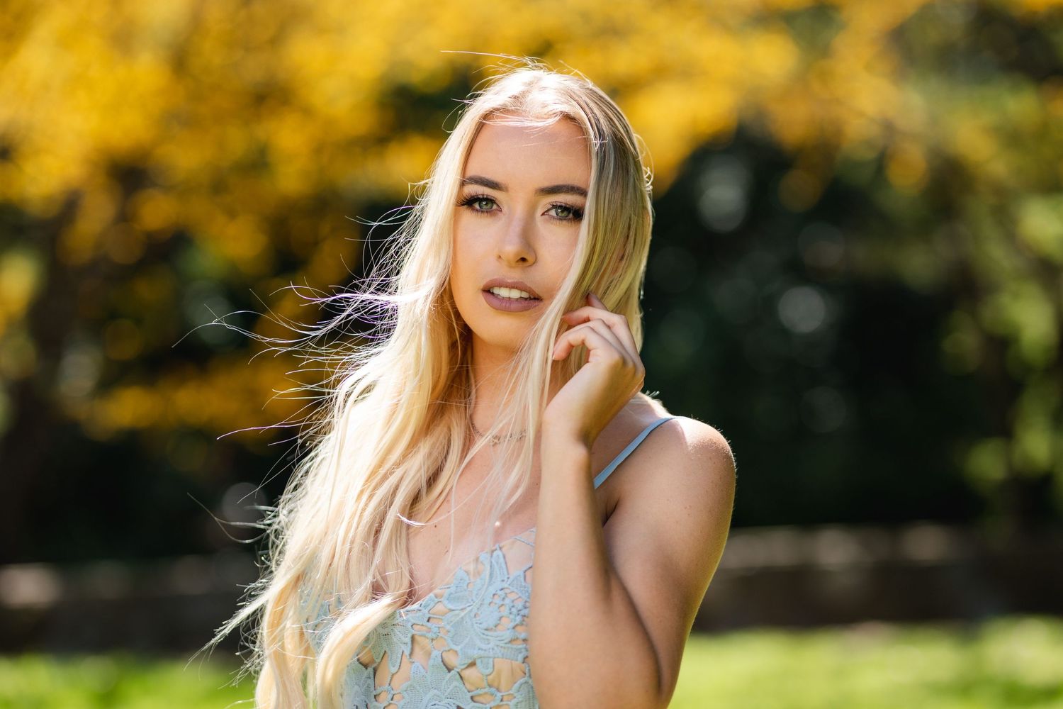 Portrait with soft lighting against yellow autumn foliage background.