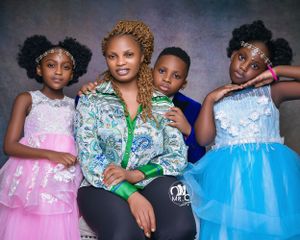 Group portrait featuring four people in formal dresses against purple background.