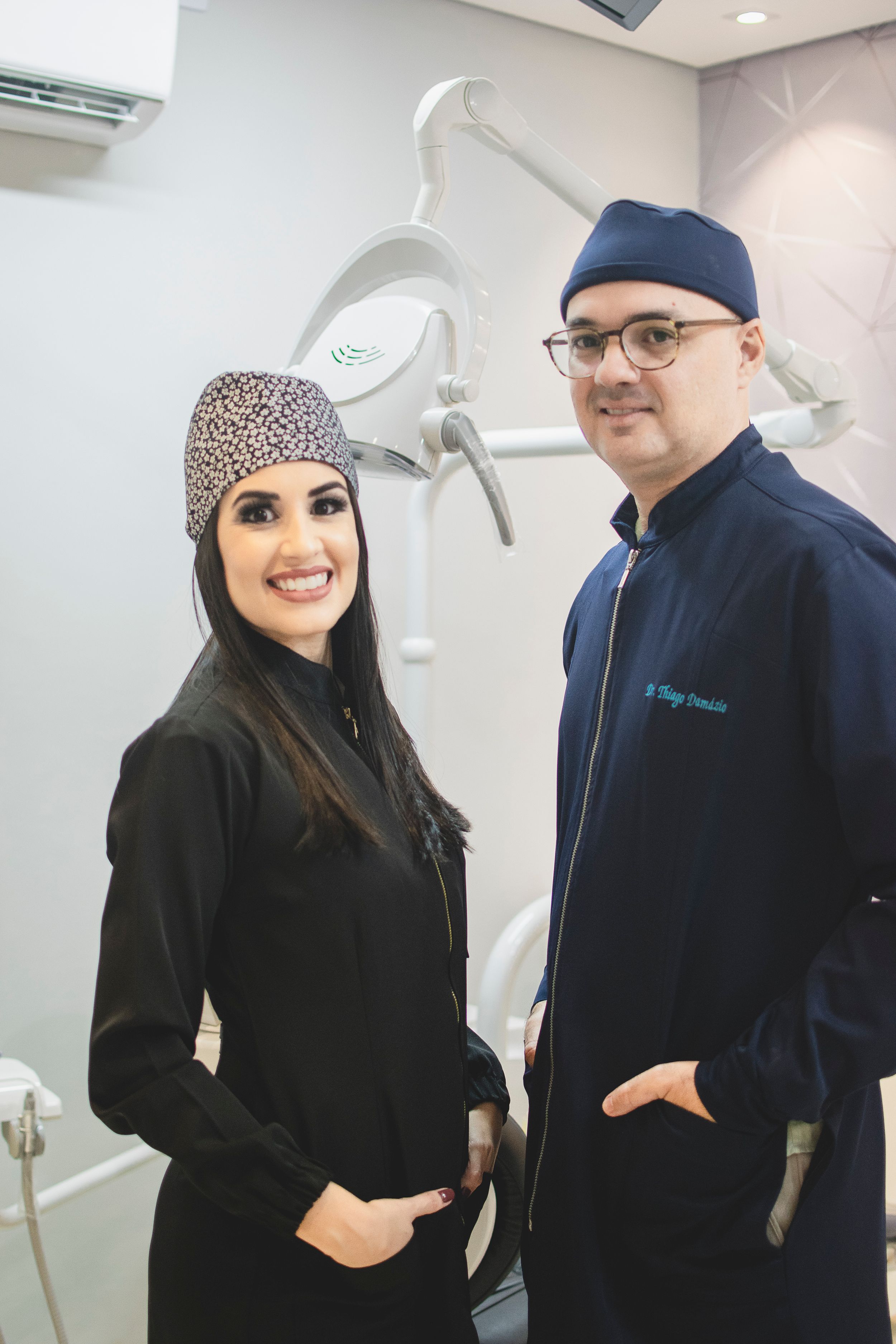 Healthcare team members sharing a friendly moment in a modern dental office setting.
