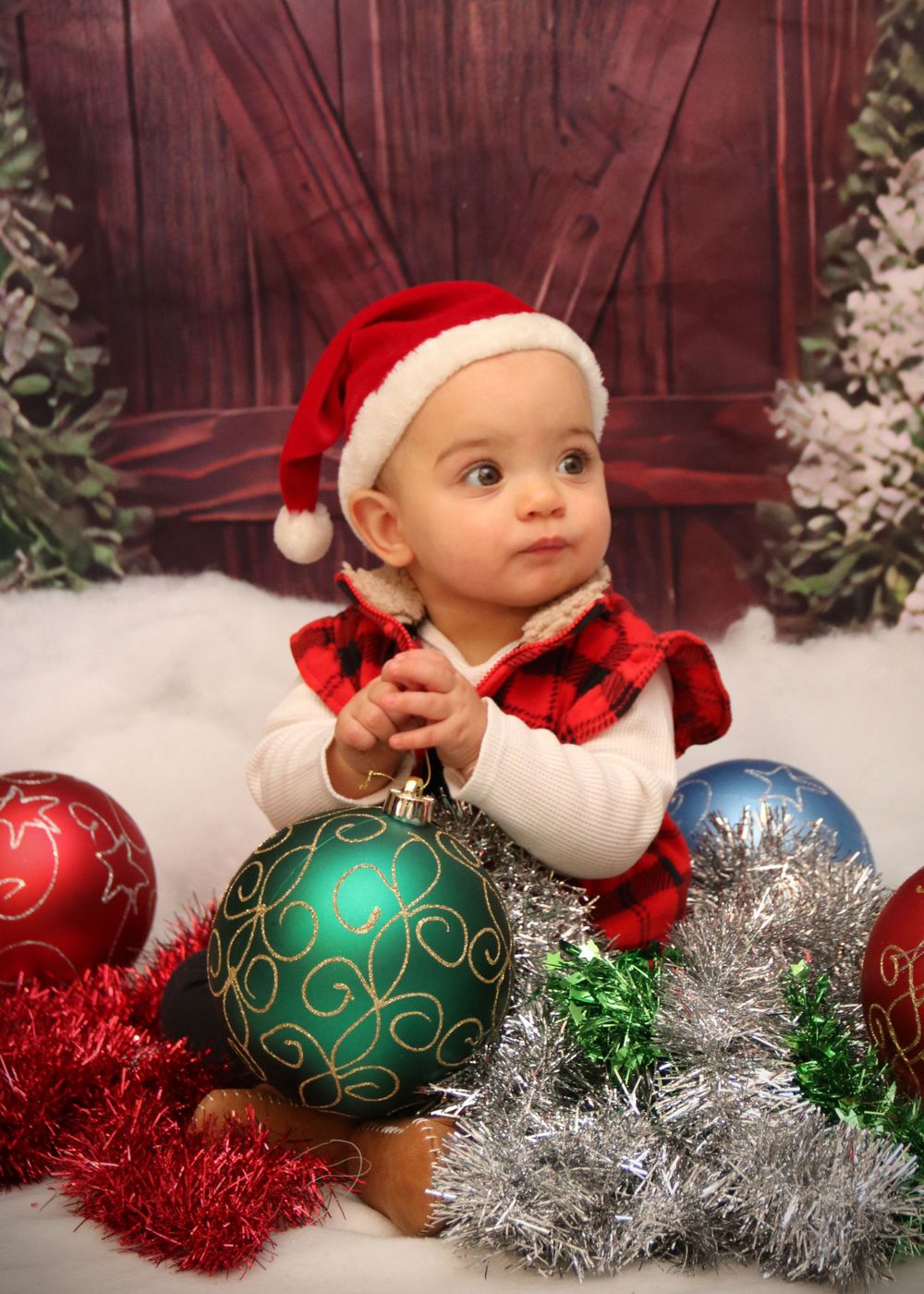 Holiday photo with Christmas ornaments, buffalo plaid, and festive decorations.