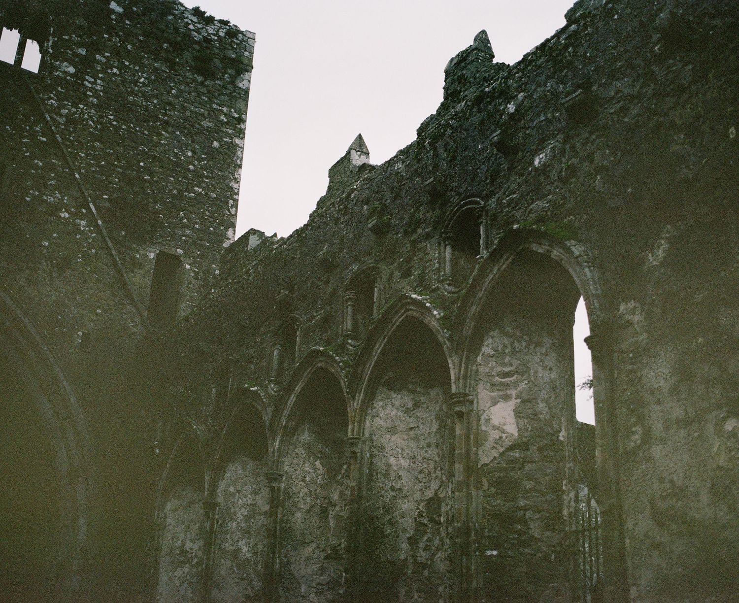 Interior view of medieval church ruins showing Gothic arches and weathered stone walls.