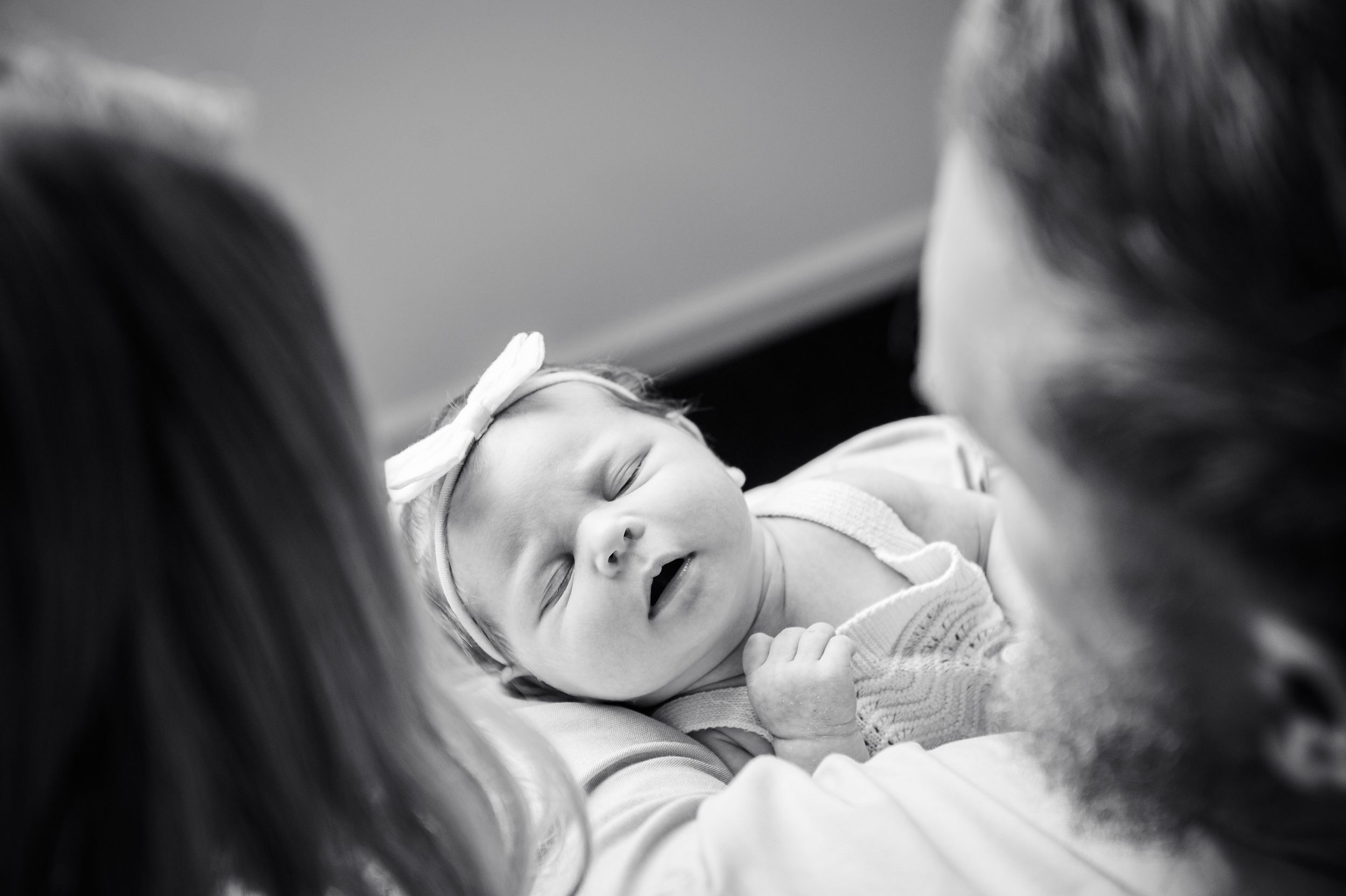 Black and white portrait of newborn being cradled during tender family moment.
Altona Family Photographer Melbourne