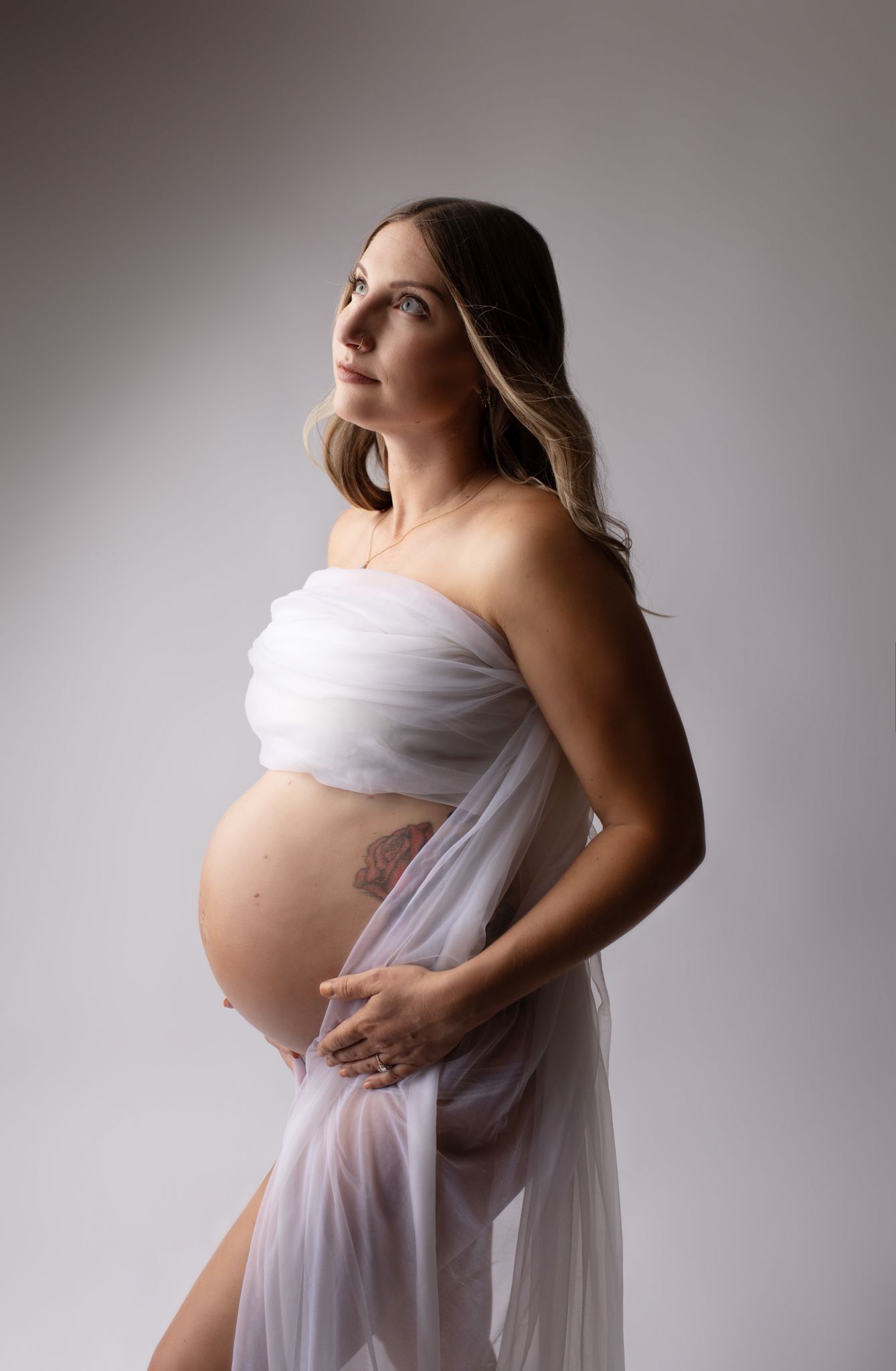 eden-prairie-maternity-photographer | white pregnant woman on white background with sheer dress draped across her chest