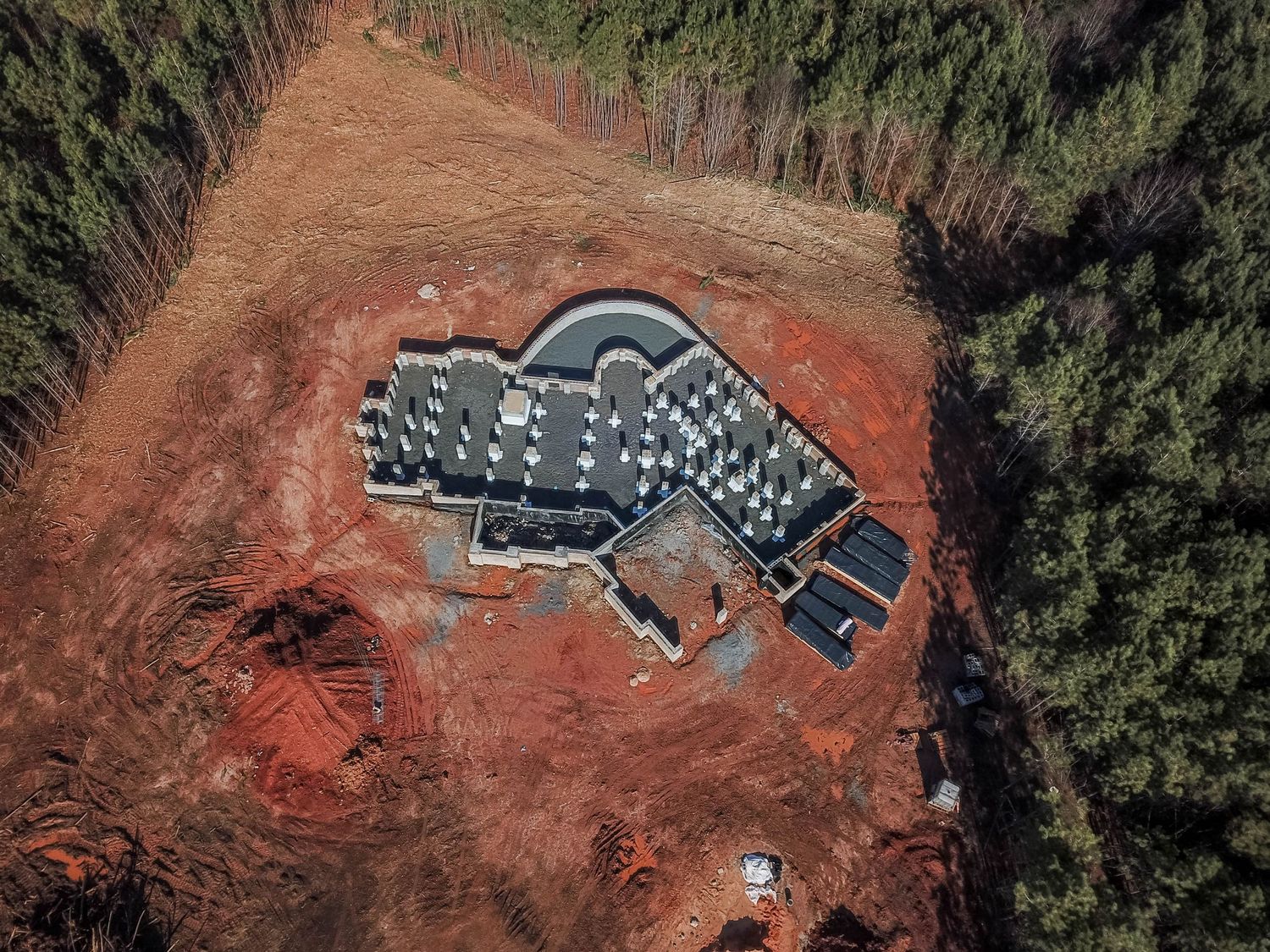 Aerial photograph of a building foundation under construction with installed concrete pillars.