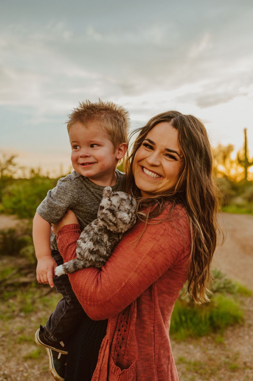 Sweet candid moments captured in warm sunset light with desert scenery.