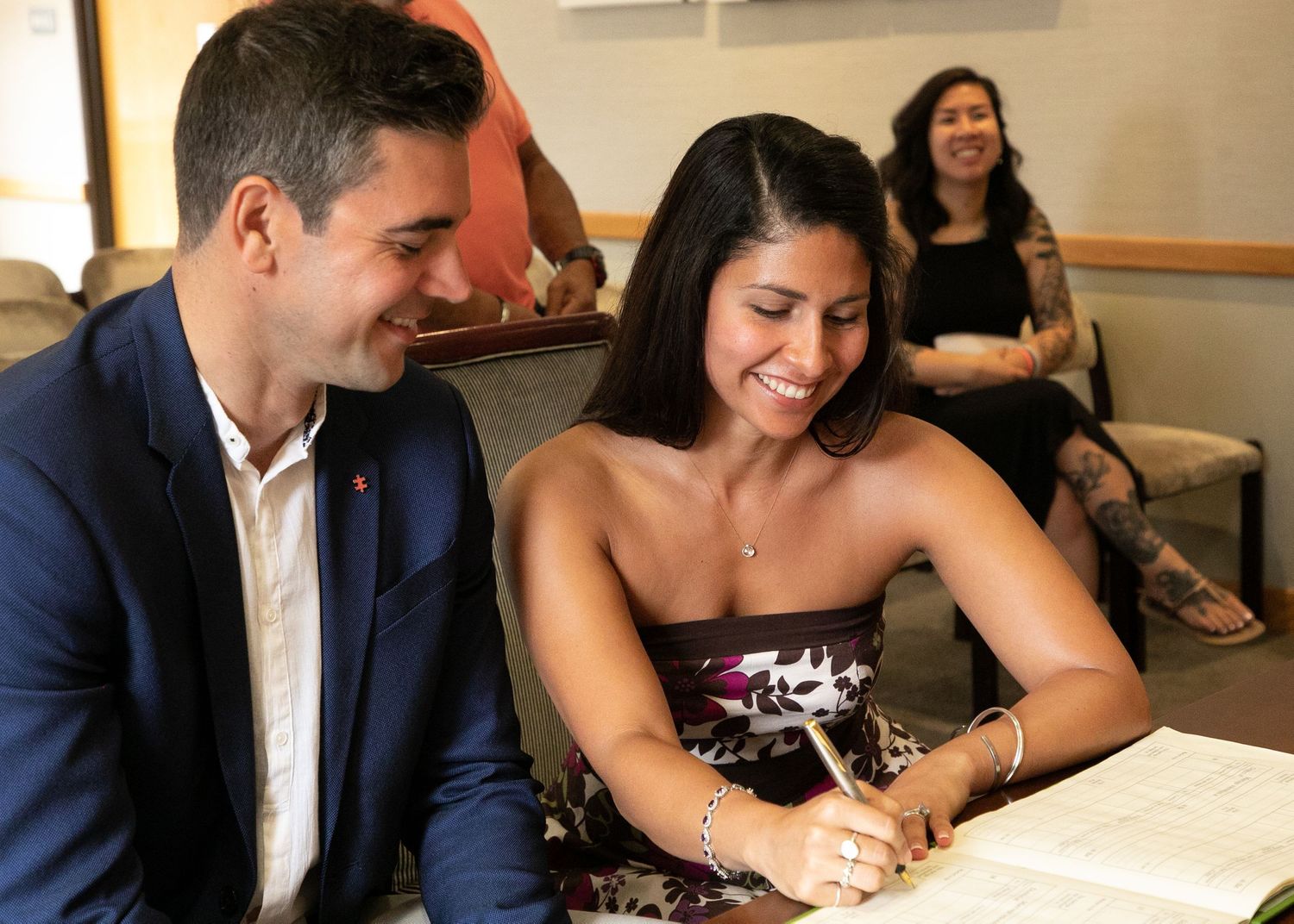 couple signing book at registry office at intimate wedding