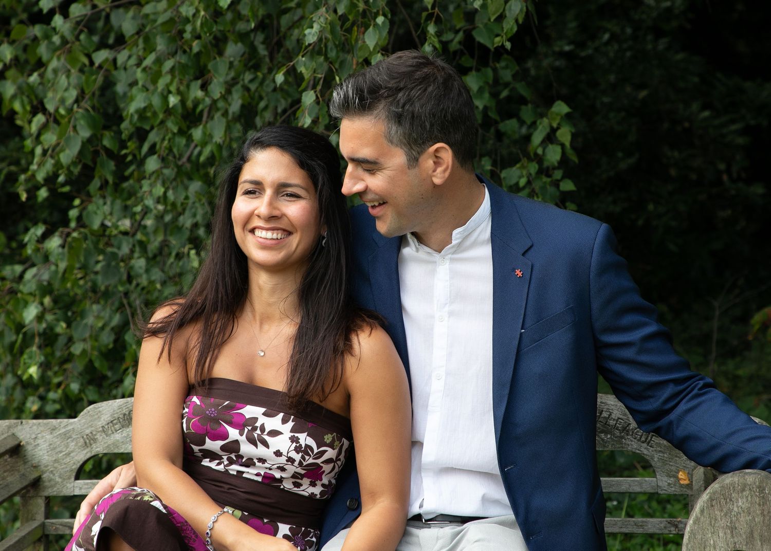 laughing bride and groom on bench at intimate wedding