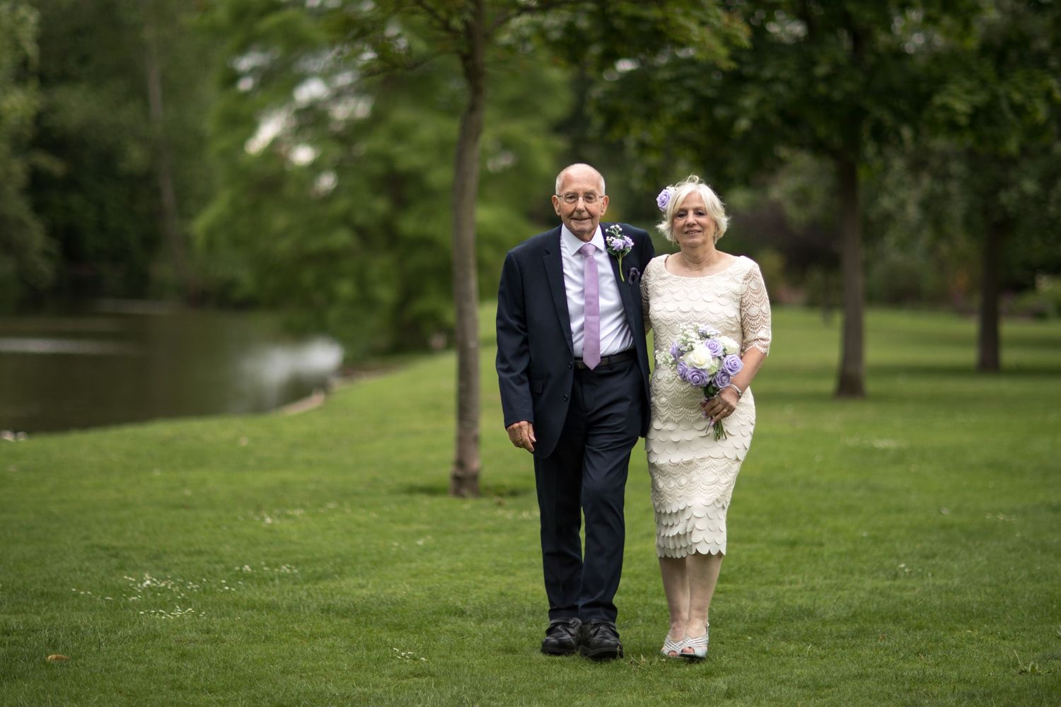 eloped couple walking by the lake at intimate wedding