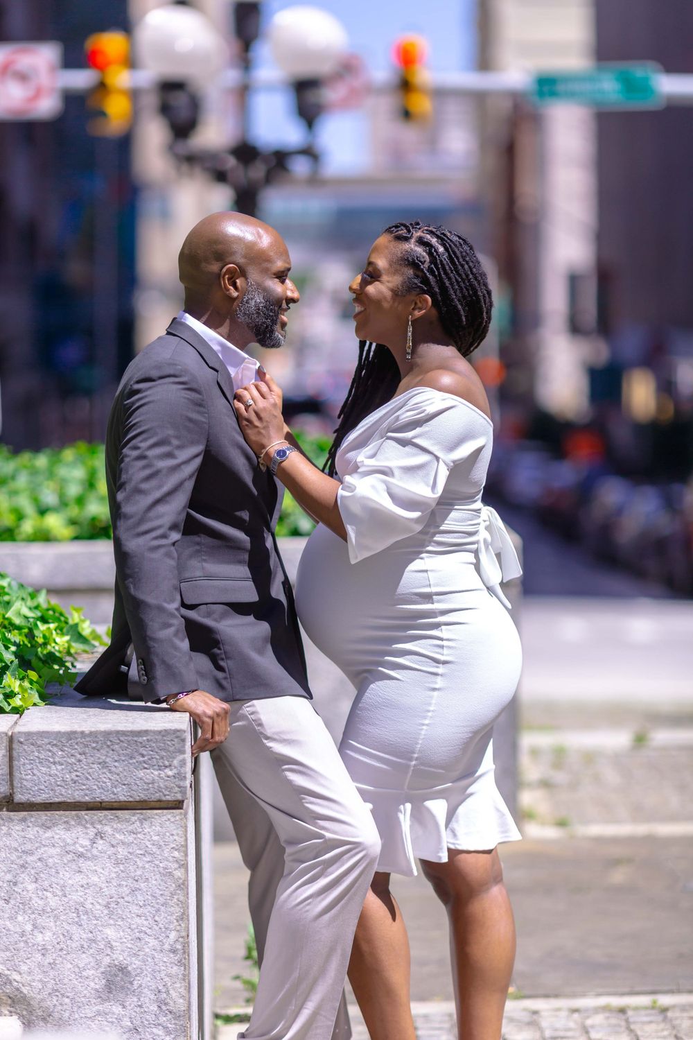 Pregnant bride smiling at husband