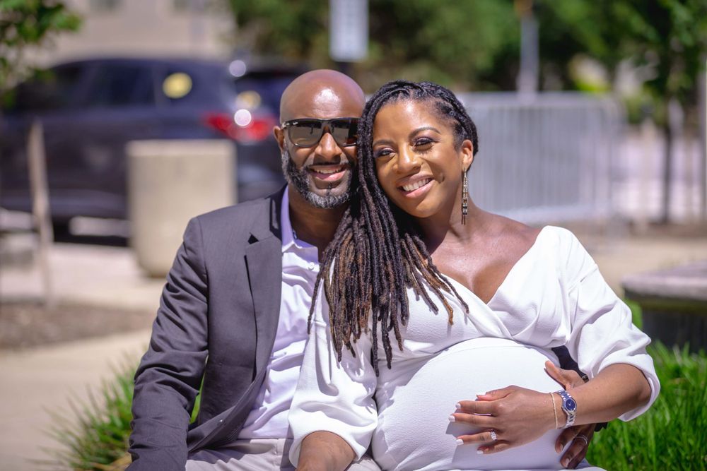 Husband hugging pregnant bride and smiling