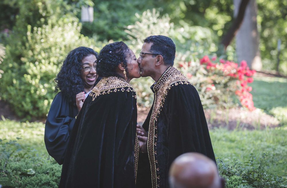 Married couple first kiss at Ethiopian and Indian wedding