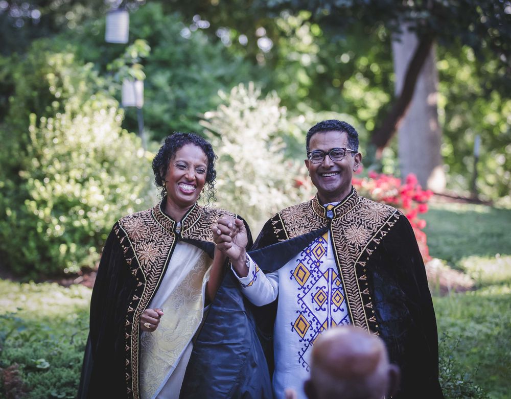 Married couple walking out after ceremony at Ethiopian and Indian wedding