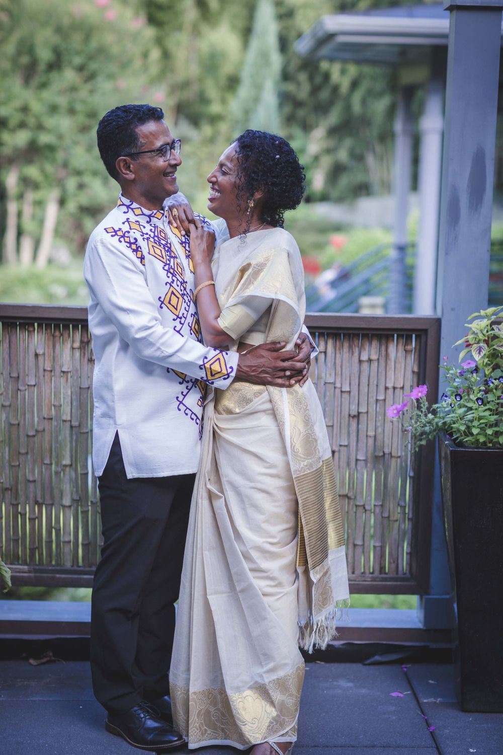 Married Ethiopian bride and Indian groom posing for picture
