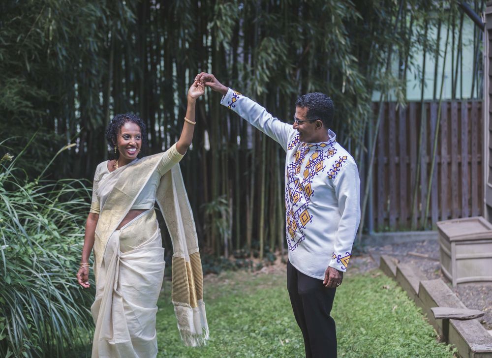 Married Indian groom spinning around his Ethiopian bride for picture