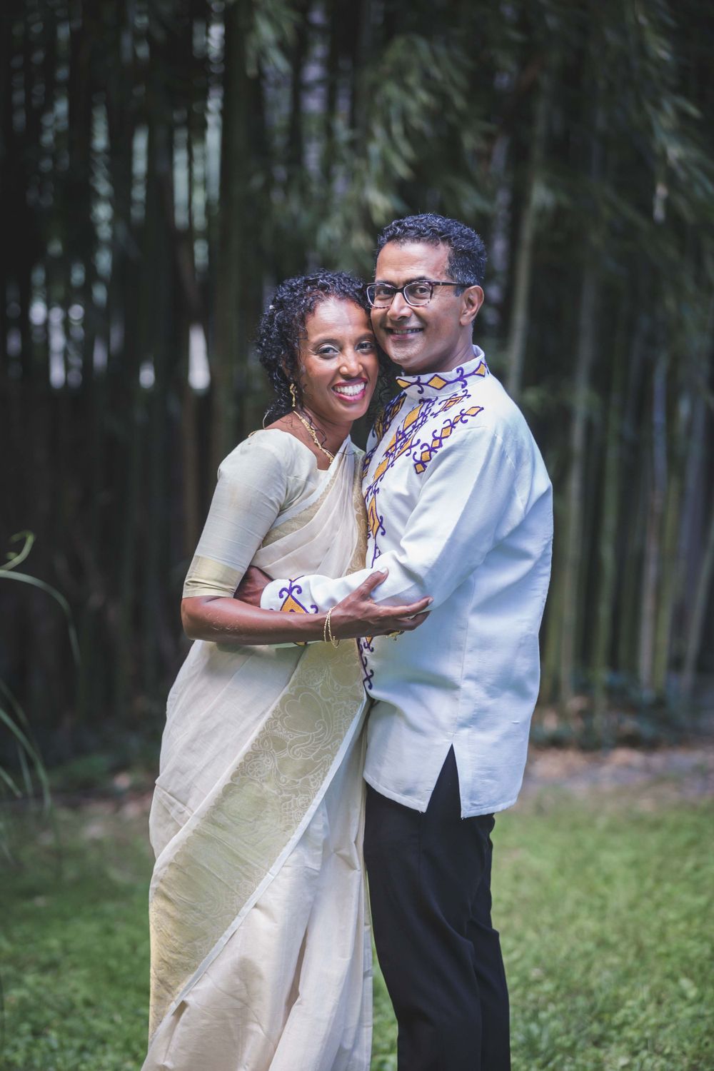 Married Ethiopian bride and Indian groom posing for picture