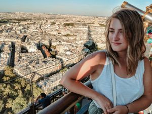 Person enjoying scenic cityscape view from elevated viewpoint during daytime.