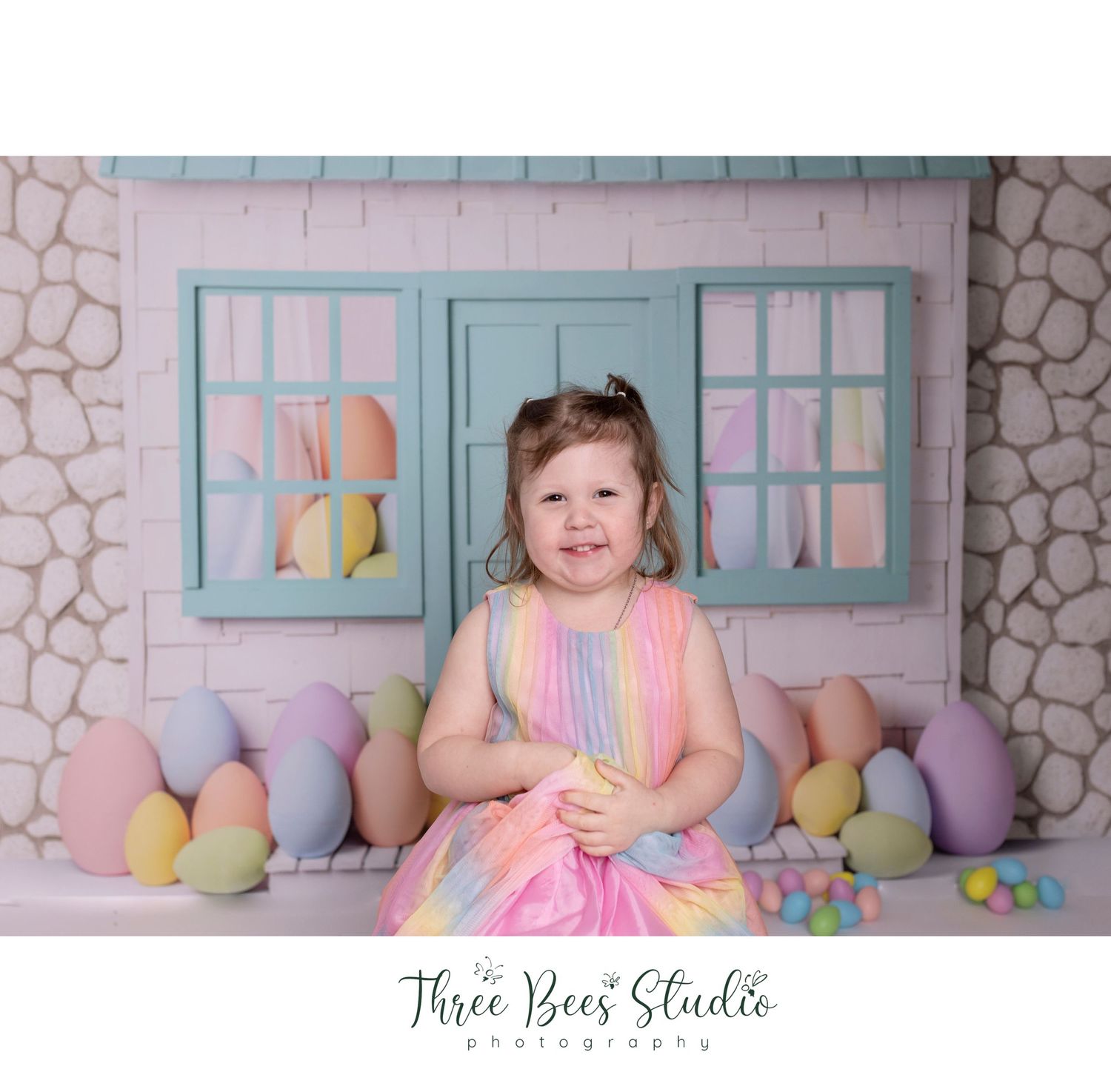 Pastel Easter photo setup with colorful eggs and blue vintage windows.