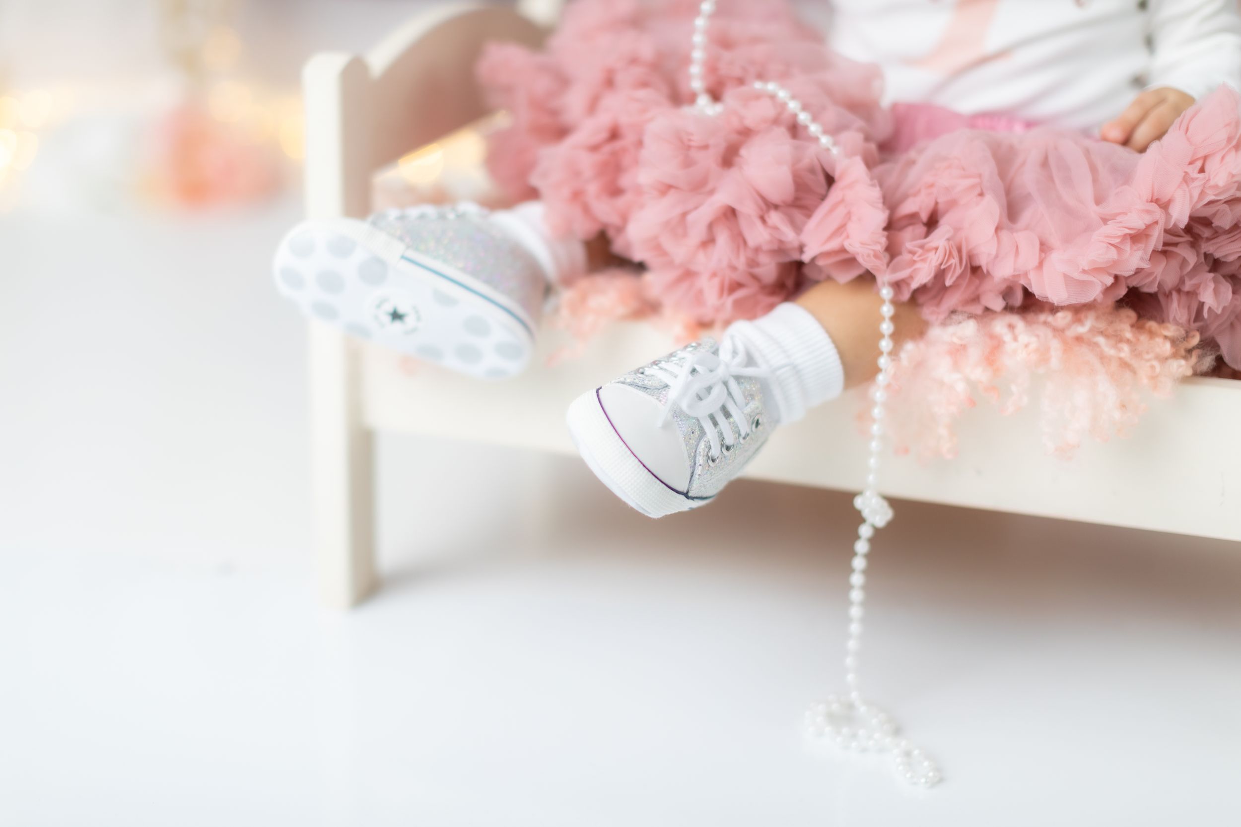 Delicate white and pink decorative elements for photography session.