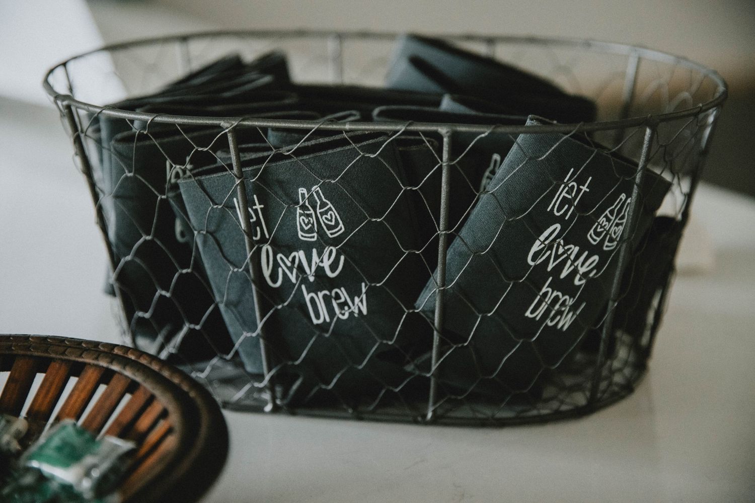 A black wire mesh basket containing dark-colored items with small text or labels visible on them.