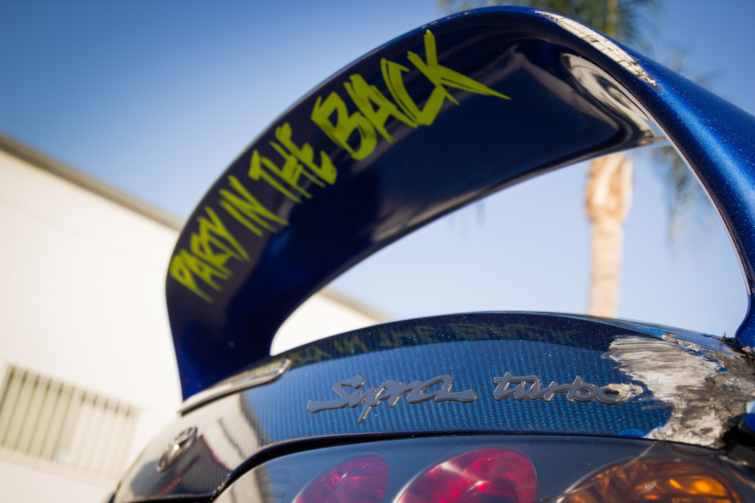 Under side of Dan Burkett's Formula Drift Supra's rear wing with Party in the Back decal.