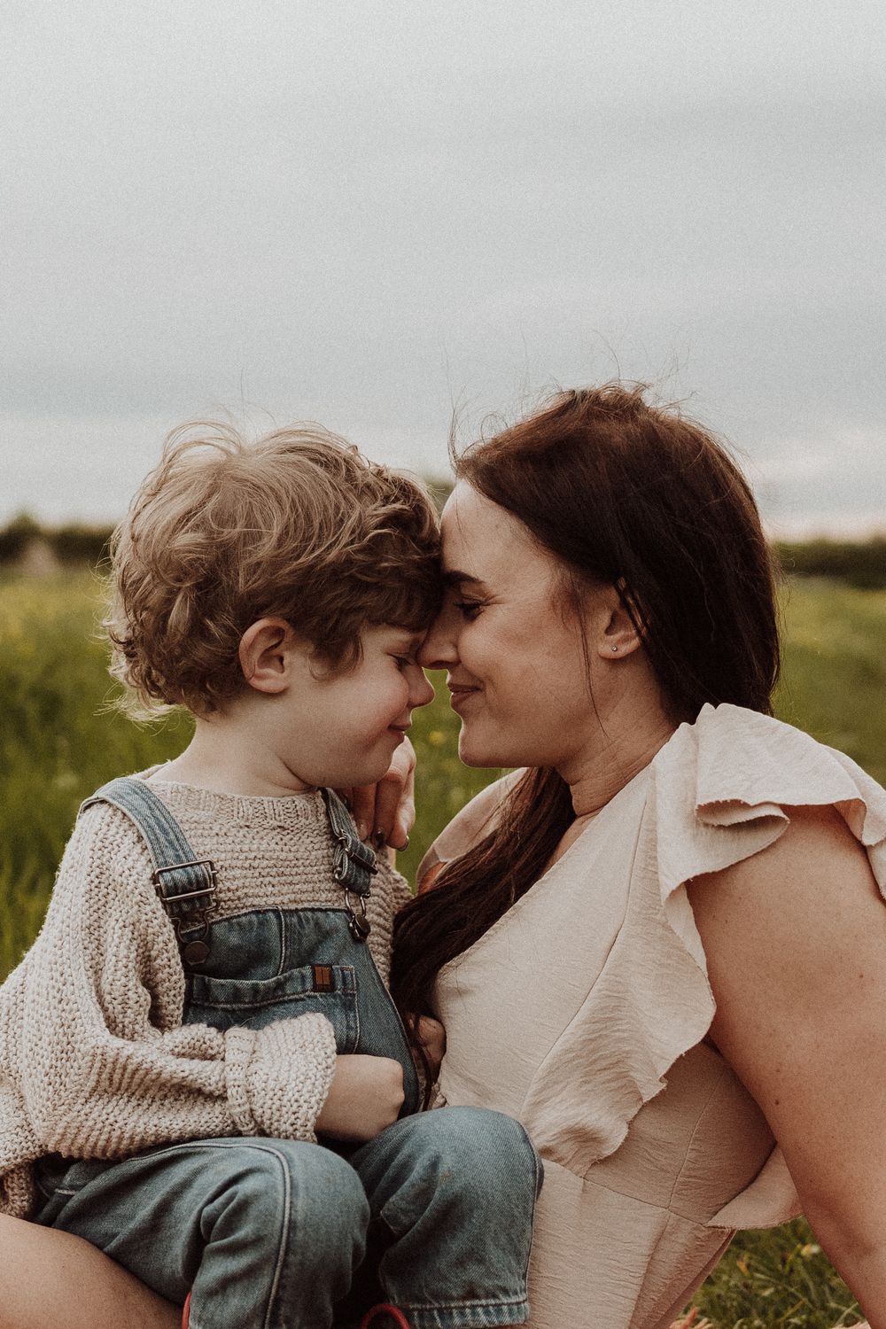 mother and son touch foreheads during their photoshoot