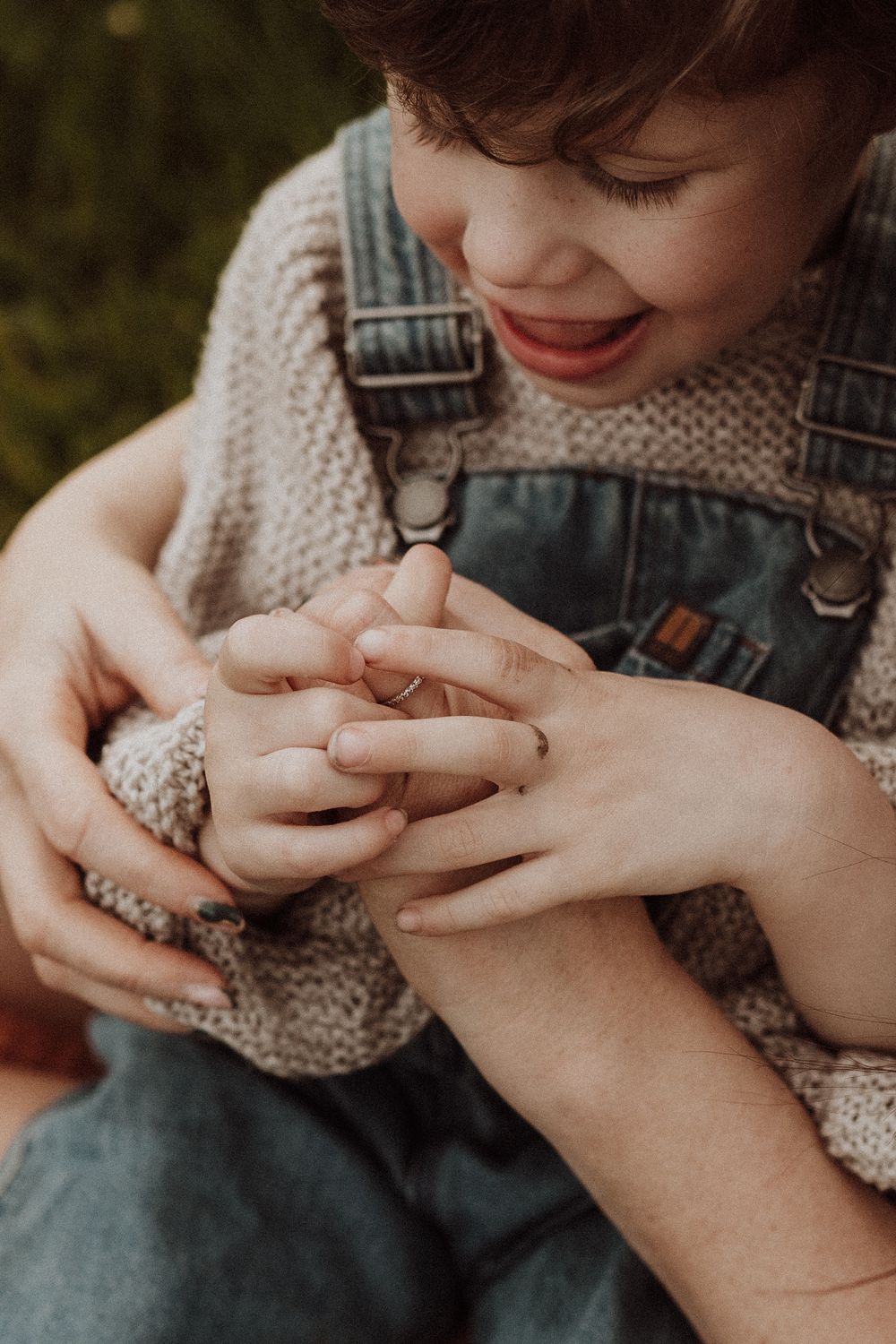 close up photo of mum and sons hands together