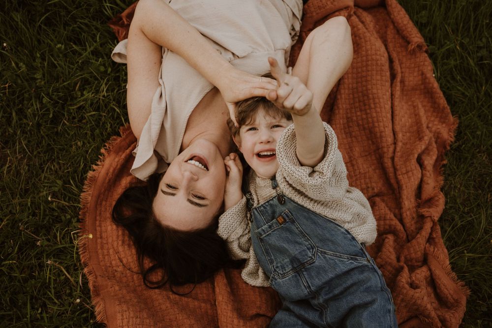 son points towards the sky during cosy family photoshoot in Whitminster, Gloucestershire