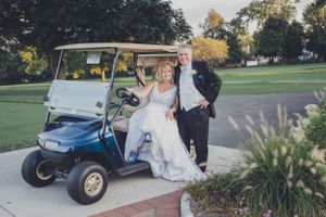 Golf cart decorated for wedding transportation on a sunny autumn day.