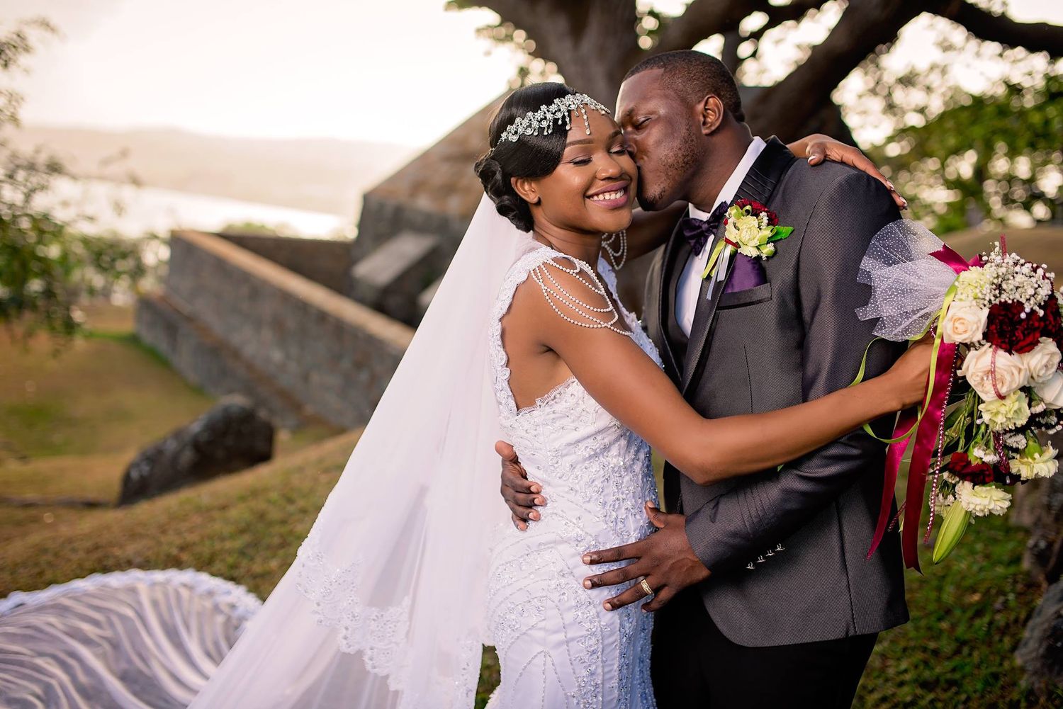 A joyful wedding moment captured at sunset near historic stone walls.