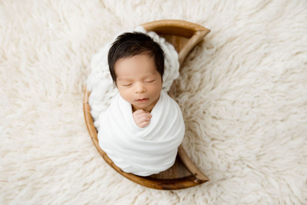 Newborn baby boy, white set up in moon newborn prop. McHenry, IL